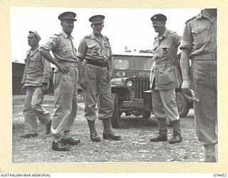 LAE, NEW GUINEA. 1944-07-06. VX20321 LIEUTENANT GENERAL H.C.H. ROBERTSON, CBE, DSO, GOC, 3RD AUSTRALIAN CORPS (1); AND MEMBERS OF A DELEGATION OF BRITISH ARMY OFFICERS ON THE AIRSTRIP PRIOR TO ..