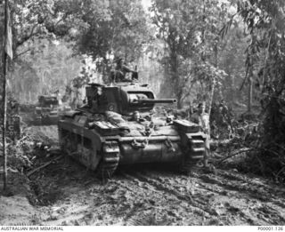 THE SOLOMON ISLANDS, 1945-04-24/27. MATILDA TANKS OF 2/4TH AUSTRALIAN ARMOURED REGIMENT TRAVELLING ALONG A DIRT ROAD ON BOUGAINVILLE ISLAND. (RNZAF OFFICIAL PHOTOGRAPH.)