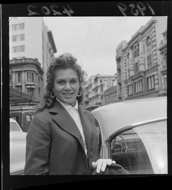 Portrait of visiting beauty queen 'Miss New Caledonia' [Mlle Huguette Aubry?] on a Wellington City street