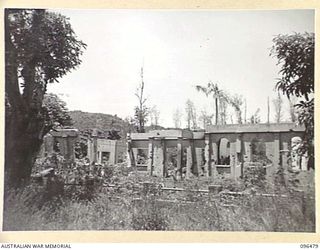 RABAUL, NEW BRITAIN, 1945-09-11. ALL BUILDINGS AND INSTALLATIONS AT RABAUL WERE DESTROYED BY ALLIED AIR ATTACKS. THIS PHOTOGRAPH SHOWS THE RUINS OF A BUILDING IN MANGO AVENUE THOUGHT TO BE EITHER ..