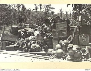 NAMBARIWA POINT, NEW GUINEA. 1944-01-25. UNWANTED 4TH INFANTRY BATTALION EQUIPMENT AWAITING SHIPMENT FROM THE BEACH AT NAMBARIWA BY MEMBERS OF THE 9TH DIVISION SALVAGE UNIT. THE STEEL HELMET HAS ..