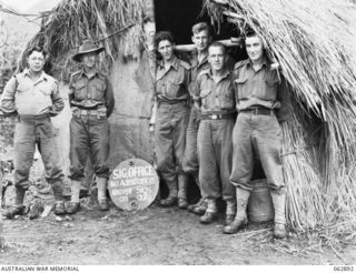 RAMU VALLEY, NEW GUINEA. 1944-01-15. SIGNAL PERSONNEL OF THE 58/59TH INFANTRY BATTALION, 15TH INFANTRY BRIGADE AT THE DOOR OF THEIR OFFICE. THEY ARE: V215893 SIGNALMAN L. W. HICKS (1); VX102577 ..