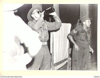 TOROKINA, BOUGAINVILLE. 1945-04-12/13. A SCENE FROM A SKIT "A COMMANDING OFFICER'S INSPECTION" DURING A CONCERT STAGED BY 7 FIELD AMBULANCE PERSONNEL. PRIVATE N.L. GEE, ACTING AS COMMANDING OFFICER ..