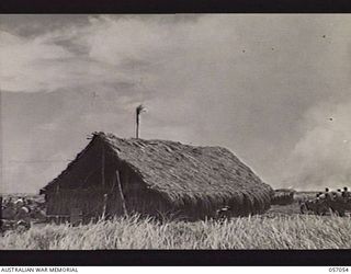 NADZAB AREA, NEW GUINEA. 1943-09-20. NO. 2 NADZAB AIRSTRIP CONTROL POINT SHOWING DENSE CLOUDS OF SMOKE IN THE BACKGROUND, COMING FROM BURNING KUNAI GRASS IGNITED BY JAPANESE BOMBS