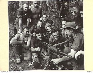 1943-09-14. NEW GUINEA. KOMIATUM RIDGE. MEMBERS OF THE A.I.F. TEST A JAPANESE TYPE 92 MACHINE GUN CAPTURED ON KOMIATUM RIDGE. THIS TYPE OF MACHINE GUN IS KNOWN TO THE AUSTRALIANS AS THE ..