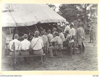 BUIN AREA, BOUGAINVILLE. 1945-09-13. JAPANESE STAFF OFFICERS WAITING OUTSIDE THE MARQUEE BEFORE A CONFERENCE WITH AUSTRALIAN OFFICERS AT HEADQUARTERS 2 CORPS SURRENDER PARTY CAMP IN KAHILI AREA TO ..
