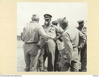 TOROKINA, BOUGAINVILLE ISLAND. 1944-12-15. VX38969 MAJOR GENERAL W. BRIDGEFORD, CBE, MC, GOC, 3RD DIVISION CHATTING WITH COMMODORE M. MORAN, UNITED STATES NAVY, AT NO 4 WHARF WHILE WAITING TO BID ..