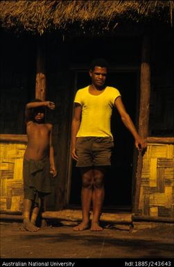 Man and boy outside of house