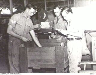 LAE, NEW GUINEA, 1946-01-02. CORPORAL (CPL) K. P. CHILDS (1) CPL L. C. FARRELL (2) AND PRIVATE J. P. FARR (3), SORTING MAIL AT 1 POSTAL UNIT