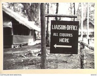 TOKO, BOUGAINVILLE. 1945-06-30. SIGN:- LIAISON OFFICE ERECTED AT HEADQUARTERS 3 DIVISION