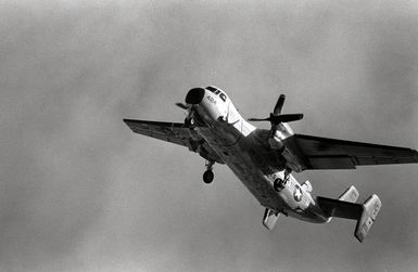 A Fleet Logistic Support Squadron 50 (VRC-50) C-2A Greyhound aircraft passes over part of the station while conducting touch-and-go landing operations