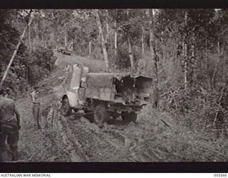 DONADABU, NEW GUINEA. 1943-07-26. SALVAGING A BOGGED TRUCK BY MEANS OF A WIRE ROPE AND A WINCH