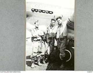 PAPUA, NEW GUINEA. 1942-07-27. THREE FIGHTER PILOTS OF THE ROYAL AUSTRALIAN AIR FORCE WHO HAVE SEEN ACTION OVERSEAS AND ARE NOW FIGHTING JAPANESE ZERO PLANES OVER NEW GUINEA MOUNTAINS. LEFT TO ..