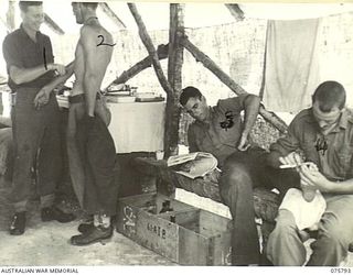 A busy scene in the regimental aid post of the 61st Infantry Battalion "the Queensland Cameron Highlanders". Identified, left to right: Q28817 Lance Corporal (LCpl) Wilfred Conrad Weise; N227567 ..