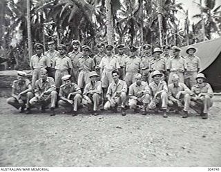 LUNGGA, GUADALCANAL, BRITISH SOLOMON ISLANDS PROTECTORATE. 1943-10-14. GROUP PORTRAIT OF THE BASE STAFF OF THE DISTRICT SUPERVISING INTELLIGENCE OFFICE. LEFT TO RIGHT, BACK ROW: SUB LIEUTENANT R ..