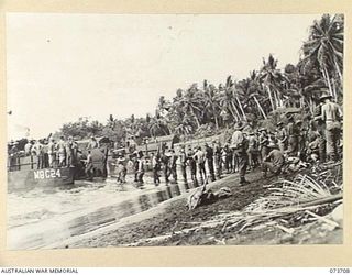 SARANG, NEW GUINEA. 1944-05-31. TROOPS OF THE 37/52ND INFANTRY BATTALION LANDING ON THE BEACH. THE AREA IS USED AS A FORWARD BASE DURING PREPARATIONS FOR THE ATTACK ON KARKAR ISLAND