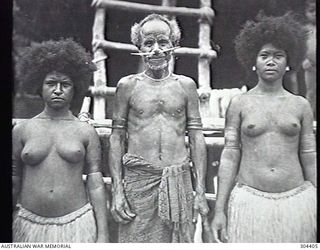 PORT MORESBY, PAPUA. 1932-09-17. TWO NATIVE WOMEN AND AN OLD MAN DRESSED TRADITIONALLY. (NAVAL HISTORICAL COLLECTION)