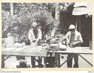 BONIS PENINSULA, BOUGAINVILLE. 1945-09-15. JAPANESE NAVAL TROOPS PREPARING FRESH VEGETABLES FOR COOKING AT THE JAPANESE NAVAL HEADQUARTERS, BONIS PENINSULA. THE HEADQUARTERS ARE SET UP IN COCONUT ..