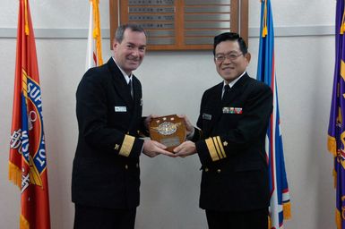 U.S. Navy Rear Adm. Raymond Berube (left), Commander, Fleet and Industrial Supply Centers accepts a plaque from Japan Maritime Self Defense Force Vice Adm. Yosinori Kawano, Commander, Maritime Materiel Command, during their meeting in Tokyo, Japan, on Dec. 5, 2006. Adm. Berube is on his first visit to the Western Pacific meeting senior military leaders in the region and touring sites in Japan, Guam and Singapore. (U.S. Navy PHOTO by Toshikuni Kiyota) (Released)