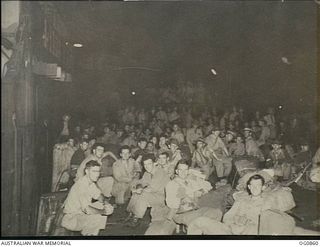VIVIGANI, GOODENOUGH ISLAND, PAPUA. 1943-11-27. INFORMAL GROUP PORTRAIT OF AIRMEN OF NOS. 22 AND 30 SQUADRONS RAAF ON THE WHARF AT NIGHT BEFORE EMBARKING ON THE SS HANYANG FOR THE MOVE FROM ..