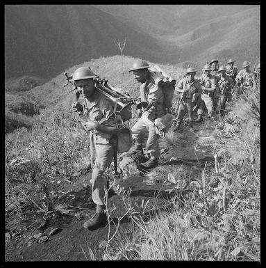 Soldiers carrying mortars up Mount Tonta, New Caledonia, during a training exercise