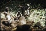 Men making petroglyph carvings