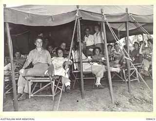 RABAUL, NEW BRITAIN. 1945-10-31. AUSTRALIAN ARMY MEDICAL WOMEN'S SERVICE PERSONNEL OF 118 GENERAL HOSPITAL RELAXING IN THEIR MESS. THE MESS IS TEMPORARILY ERECTED TENT ACCOMMODATION