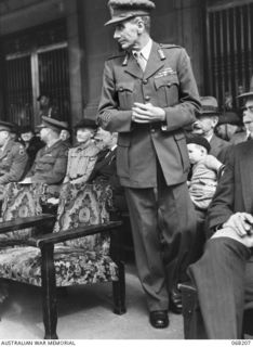 BRISBANE, QUEENSLAND, AUSTRALIA. 1944-08-08. VX9 MAJOR GENERAL G.A. VASEY, CB, CBE, DSO, AT THE SALUTING BASE FOR THE MARCH PAST OF THE 7TH DIVISION, MAJOR GENERAL VASEY COMMANDED THE DIVISION ..