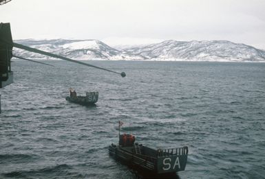 Two LCM 6 mechanized landing craft approach the amphibious assault ship USS SAIPAN (LHA 2)