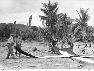 Troops of 2/10 Commando Squadron laying out markers to indicate the extremity of the Dropping Zone to Beaufort Bombers of 100 Squadron, RAAF. It was found impracticable to carry supplies using ..