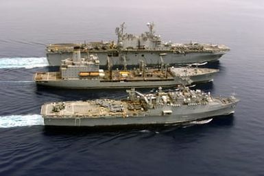 The USS SAIPAN (LHA 2) (top) conducts an Underway Replenishment (UR), with the USNS LEROY GRUMMAN (TAO 194) (center) and the USS AUSTIN (LPD 4)