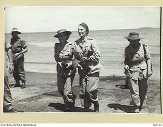 BOUGAINVILLE. 1945-03-31. LADY WAKEHURST (2), LADY BLAMEY (1), AND MISS S. GRAHAM, 2/1 GENERAL HOSPITAL (3), AFTER COMING ASHORE FROM A 42 LANDING CRAFT COMPANY VESSEL AT FREDDIE BEACH DURING THEIR ..