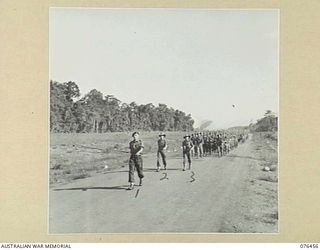 LAE, NEW GUINEA. 1944-10-07. A MARCH PAST OF THE 2/8TH COMMANDO SQUADRON. IDENTIFIED PERSONNEL ARE:- NX65553 MAJOR N.I. WINNING, OFFICER- IN- CHARGE (1); NX68278 LIEUTENANT A.C. JONES (2); WARRANT ..