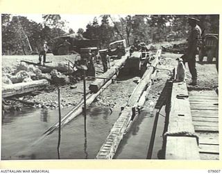 KALUMALAGI RIVER, NEW BRITAIN. 1945-02-12. PERSONNEL OF THE 17TH FIELD COMPANY, WORKING ON THE CONSTRUCTION OF A NEW 30 TON BARGE SLIPWAY NEAR THE MOUTH OF THE RIVER. IDENTIFIED PERSONNEL ARE:- ..