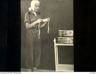 HELDSBACH MISSION, FINSCHHAFEN AREA, NEW GUINEA. 1944-03-13. VFX111205 SISTER J. SUTCLIFFE OF THE AUSTRALIAN ARMY NURSING SERVICE (AANS) PREPARING FOR AN OPERATION IN THE THEATRE AT THE 2/3RD ..