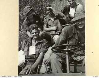 An American jeep driver brings wounded Australians, probably from the 55/53rd Battalion, to a first aid station from the front line