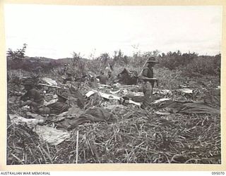 KIARIVU, NEW GUINEA, 1945-08-06. TROOPS OF 2/7 INFANTRY BATTALION ON A TREK FROM BERIMU TO THE KIARIVU AREA, DRYING OUT WET GEAR AND EQUIPMENT, DURING A SIX DAY PATROL INTO ENEMY TERRITORY