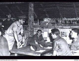 RABAUL, NEW BRITAIN, 1946-04-05. MAJOR-GENERAL B.M. MORRIS, GENERAL OFFICER COMMANDING 8 MILITARY DISTRICT, DISCUSSING WITH PRIVATE R.E. SUTHERLAND THE PROGRESS OF HIS STUDIES IN ELECTRONICS DURING ..