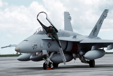 A ground crew member steps down from the cockpit of a Marine Fighter-Attack Squadron 232 (VMFA-232) F/A-18C Hornet aircraft after conducting a preflight check during Operation Tandem Thrust '93