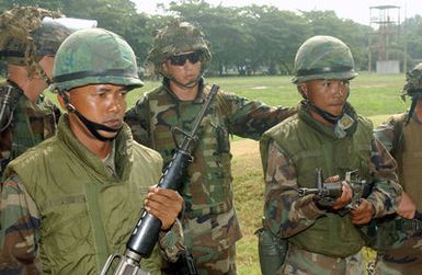 Thai Royal Marines and US Marine Corps (USMC) personnel stand shoulder to shoulder against protesters during a Non-Combatant Evacuation Operation (NEO) Exercise, in support of COBRA GOLD 2003. The US Marine Corps (USMC) personnel are attached to 1ST Battalion, 3rd Marines home based in Hawaii