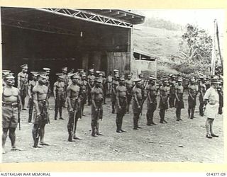 1943-03-03. PRESENTATION OF LOYAL SERVICE MEDALS AT WAU AERODROME. ON PARADE. A GUARD OF NATIVE CONSTABLES ON PARADE AT WAU AERODROME NEW GUINEA, WHEN THE G.O.C. PRESENTED LOYAL SERVICE MEDALS TO ..