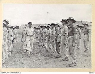 LAE AREA, NEW GUINEA. 1945-08-13. COLONEL I.J. WOOD, COMMANDING OFFICER, 2/7 GENERAL HOSPITAL, INSPECTING A COMPANY OF THE HOSPITAL STAFF