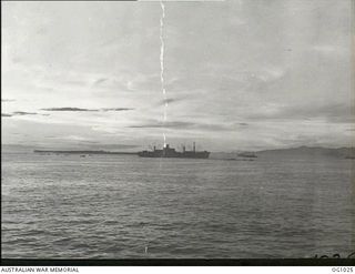 NEAR AITAPE, NORTH EAST NEW GUINEA. 1944-04-22. SHELLING AND DIVE BOMBING WHICH PRECEDED THE AITAPE LANDING AS VIEWED ACROSS THE WATER BY RAAF ENGINEERS ON THE DECK OF THEIR LANDING SHIP, TANK ..