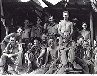 SALAMUA, NEW GUINEA. 1943-09-20. MEMBERS OF THE 11TH AUSTRALIAN FIELD COMPANY, ROYAL AUSTRALIAN ENGINEERS AT HOME IN A BADLY DAMAGED HOUSE ON THE ISTHMUS. THEY ARE:- QX52603 SAPPER R. SKINNER (1); ..