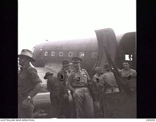 7 MILE, NEW GUINEA. 1943-11-01. THE ARRIVAL BY AIRCRAFT OF THE FIRST PARTY OF THE UNITED KINGDOM LETHBRIDGE MILITARY MISSION AT WARDS 'DROME. SHOWN: SERGEANT L.C. FOWLER (2); LIEUTENANT COLONEL D. ..