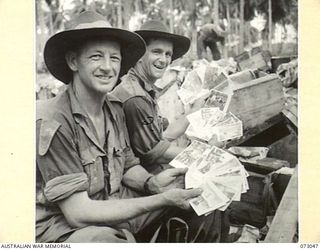 MADANG AREA, NEW GUINEA. 1944-04-27. NX88594 SAPPER J.L. DAVIDSON (1), AND NX156496 SAPPER H.R. LEE (2), MEMBERS OF THE 8TH FIELD COMPANY, ROYAL AUSTRALIAN ENGINEERS, DISPLAY "FULL HANDS" SHOWING ..