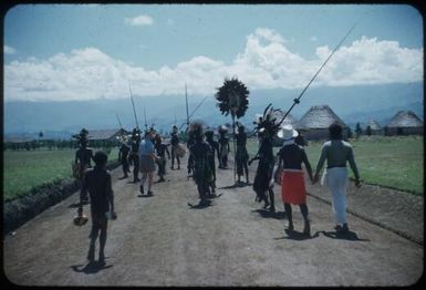We set off: Marie Reay, the anthropologist, in shorts, Binda (our haus boi in red laplap : Wahgi Valley, Papua New Guinea, 1955 / Terence and Margaret Spencer