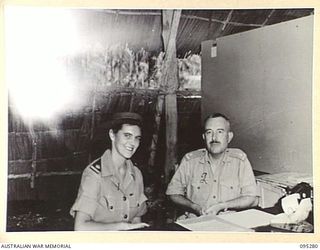 PALMALMAL PLANTATION, JACQUINOT BAY, NEW BRITAIN, 1945-08-14. MAJOR M.O. WHEELER, MATRON, AUSTRALIAN ARMY NURSING SERVICE, WITH MAJOR C.O.F. RIEGER, COMMANDING OFFICER 2/8 GENERAL HOSPITAL BEFORE ..