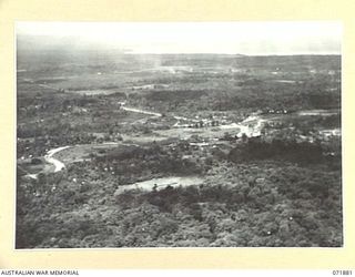 LAE, NEW GUINEA. 1944-03-30. AN AERIAL VIEW OF THE TOWN SHOWING THE SEA COAST IN THE BACKGROUND