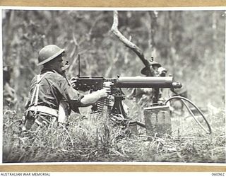 DONADABU AREA, NEW GUINEA. 1943-11-30. A VICKERS 303 MACHINE GUN CREW OF THE 2/10TH AUSTRALIAN INFANTRY BATTALION IN ACTION DURING A COMBINED EXERCISE WITH THE 2/4TH AUSTRALIAN FIELD REGIMENT. ..